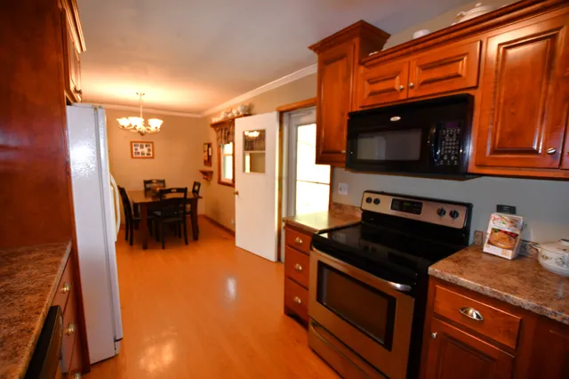 a kitchen with stainless steel appliances granite countertop a stove and a microwave