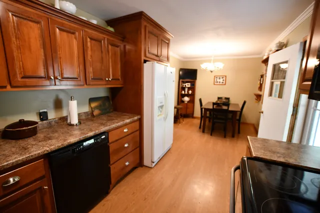 a kitchen with granite countertop lots of counter top space and cabinets