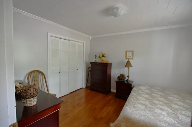 a bedroom with a bed and a dresser