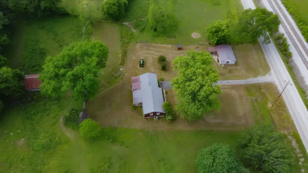 an aerial view of a house with a yard