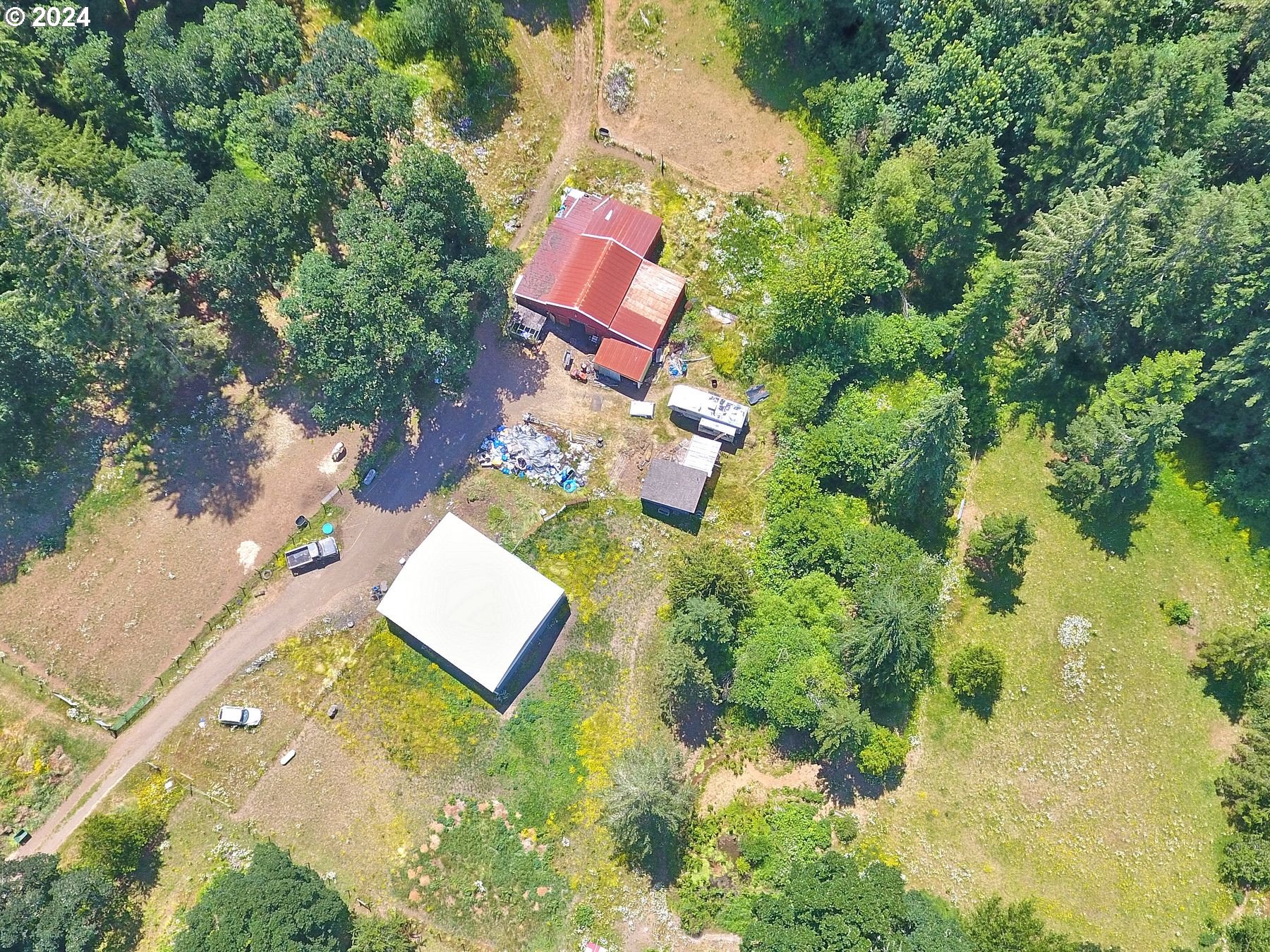 28250 Andy Riggs Road Grand Ronde, OR 97347 - Photo 18 of 48 an aerial view of a house with a yard and swimming pool