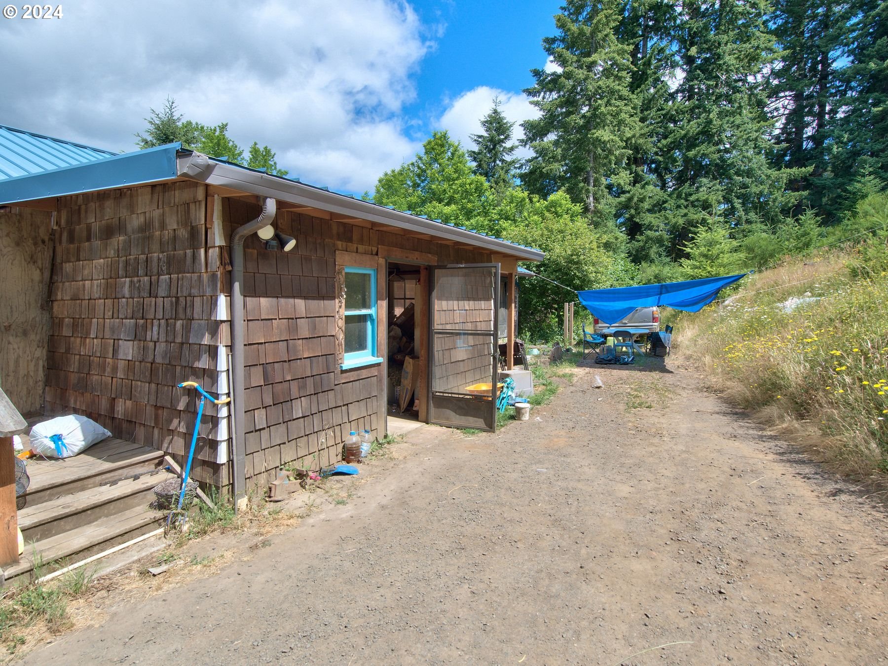 28250 Andy Riggs Road Grand Ronde, OR 97347 - Photo 33 of 48 a view of a house with a patio and a yard