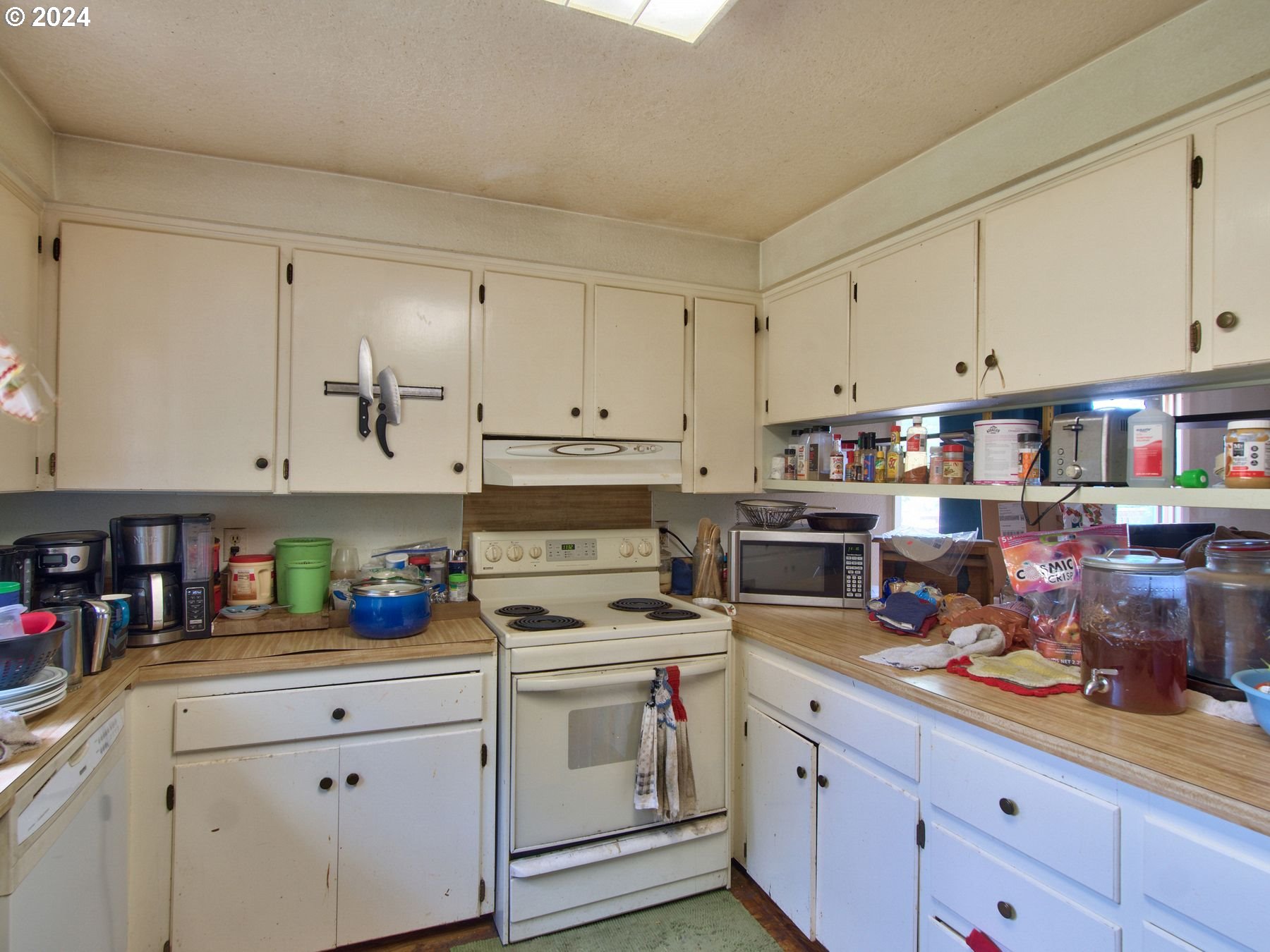 28250 Andy Riggs Road Grand Ronde, OR 97347 - Photo 38 of 48 a kitchen with cabinets stainless steel appliances and wooden floor