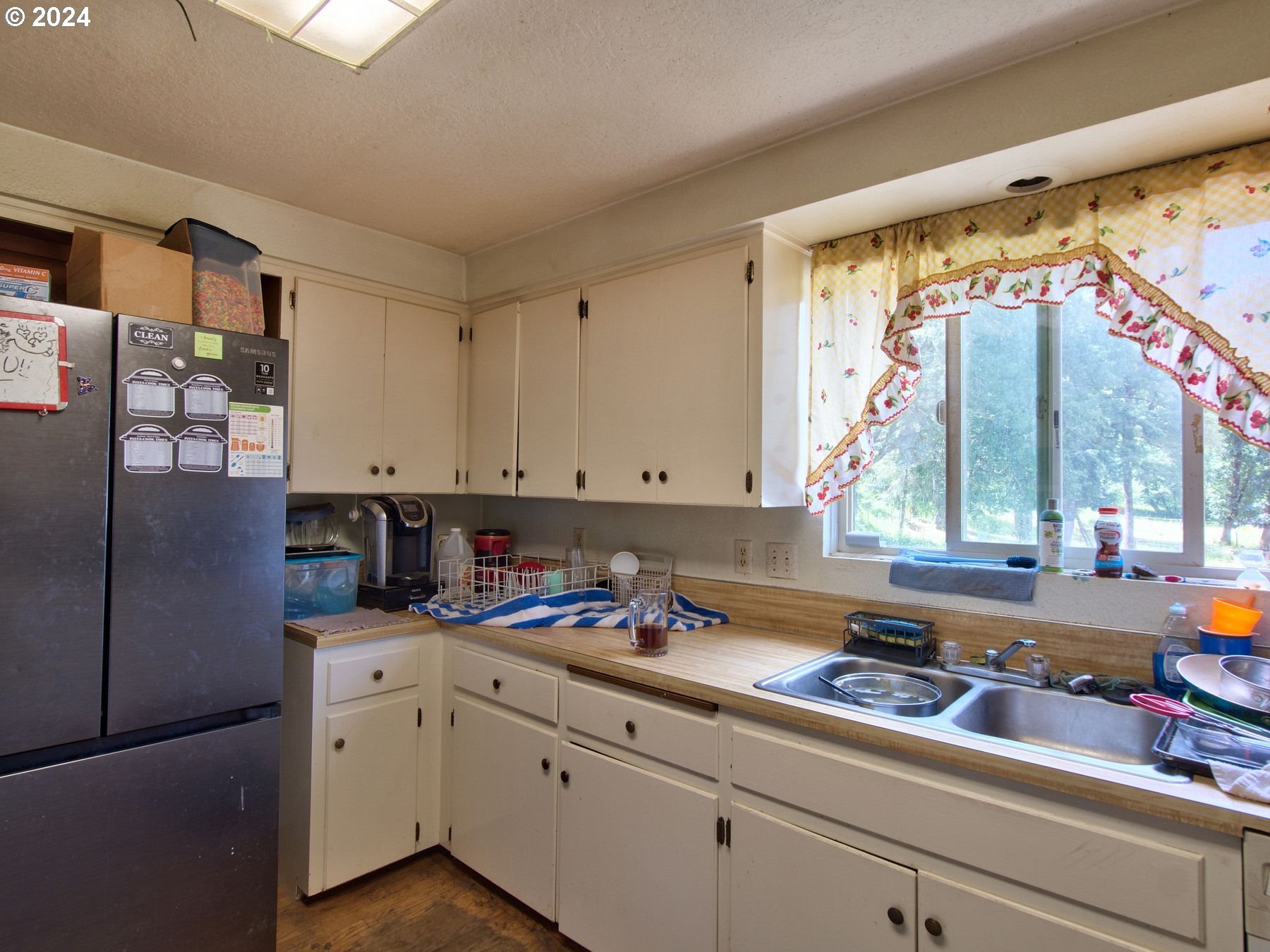 28250 Andy Riggs Road Grand Ronde, OR 97347 - Photo 39 of 48 a kitchen with stainless steel appliances a sink a refrigerator and window