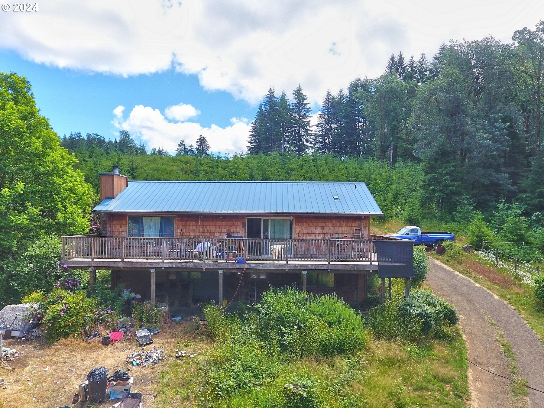 28250 Andy Riggs Road Grand Ronde, OR 97347 - Photo 4 of 48 an aerial view of a house with a garden and lake view