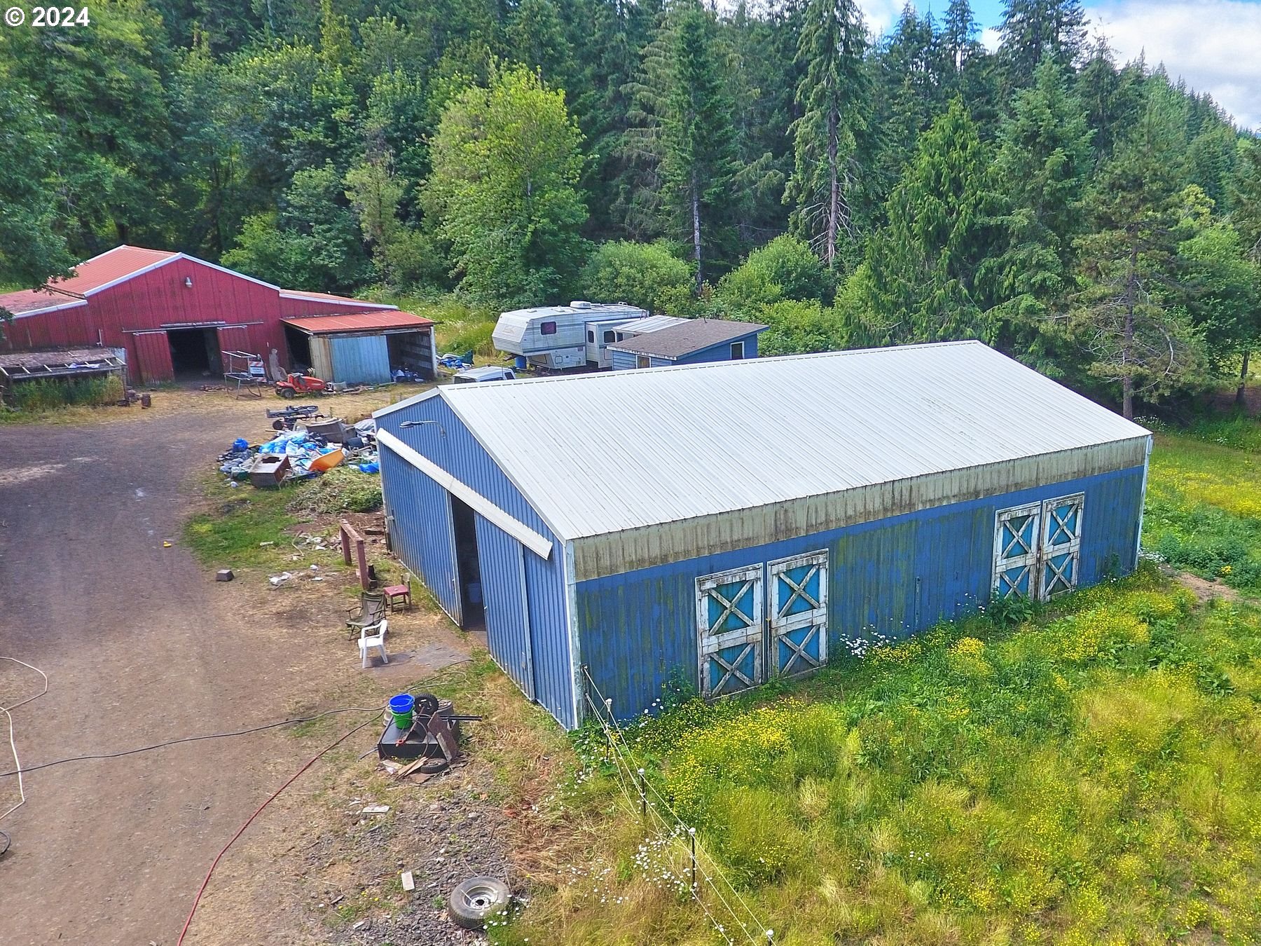 28250 Andy Riggs Road Grand Ronde, OR 97347 - Photo 6 of 48 a backyard of a house with table and chairs