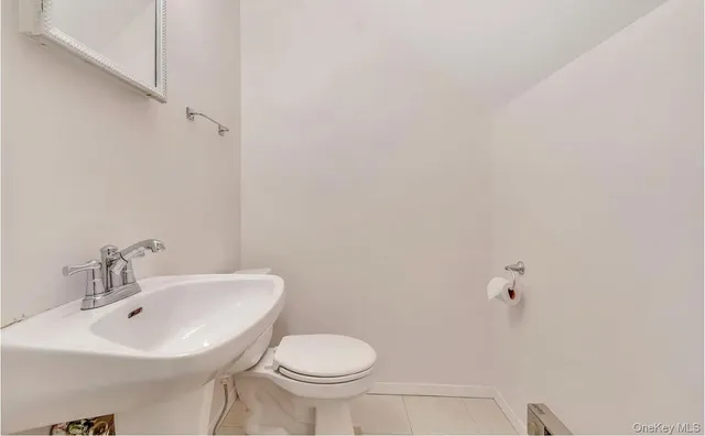 a bathroom with a sink toilet and a mirror