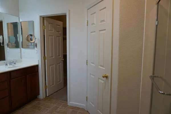 a bathroom with a tub sink and a mirror