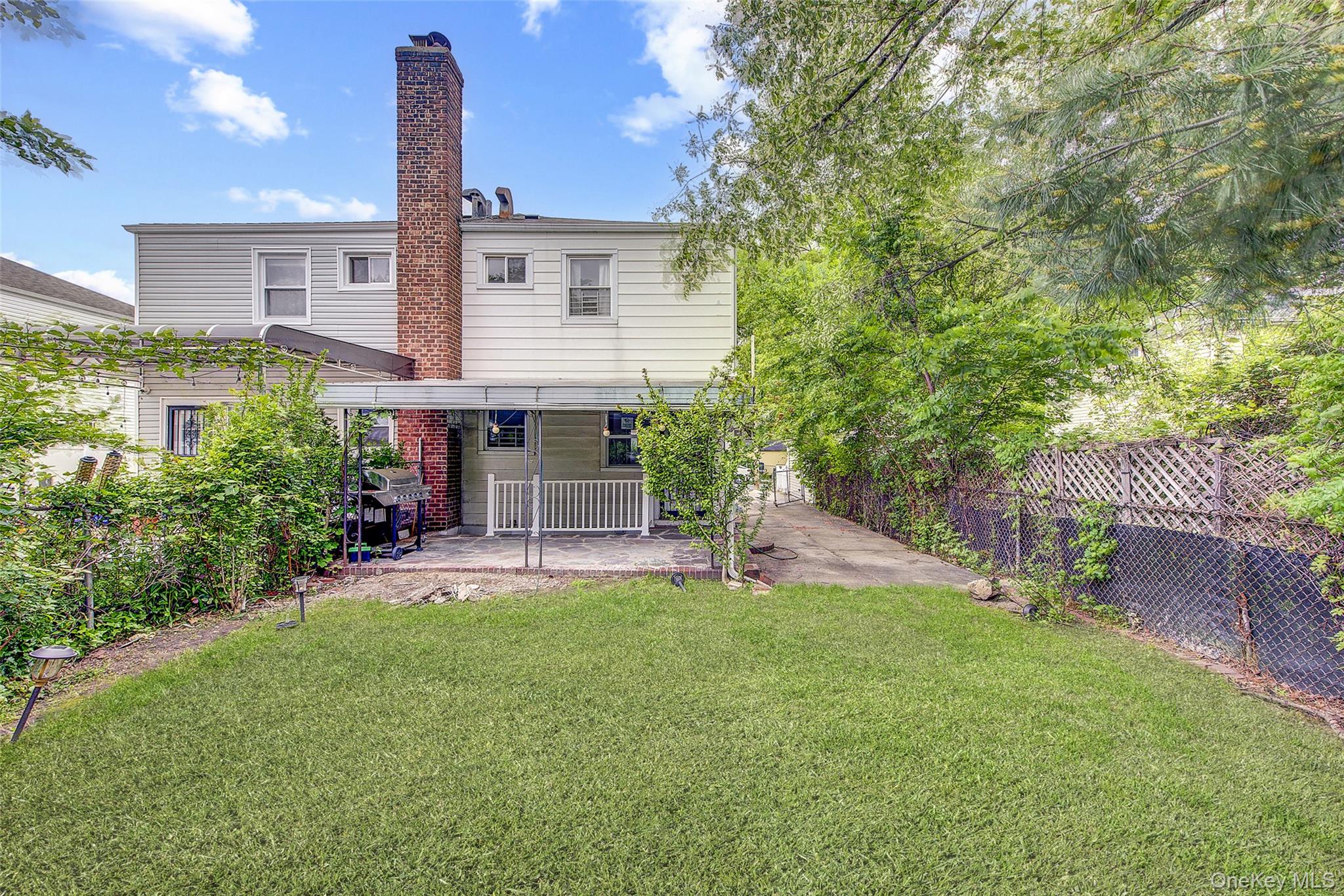 164-38 76th Road Queens, NY 11366 - Photo 44 of 44 a view of a house with a yard and sitting area