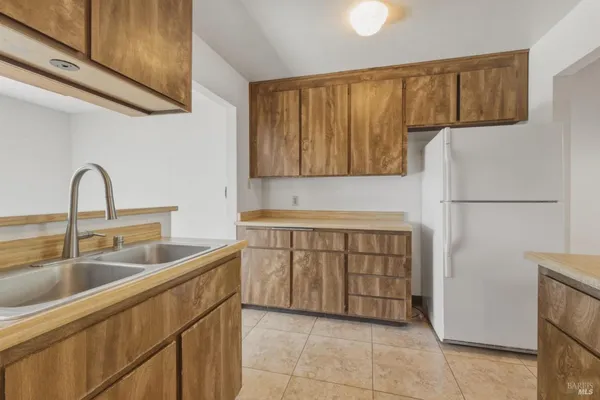a kitchen with a sink and refrigerator