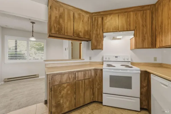 a kitchen with a stove top oven sink and cabinets