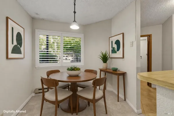 a view of a dining room with furniture and window