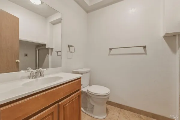 a bathroom with a sink mirror vanity and toilet