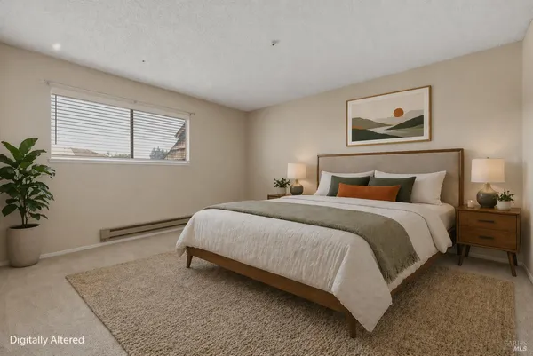 a bedroom with bed and a potted plant