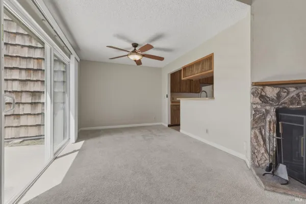 a view of empty room with a fireplace and cabinet