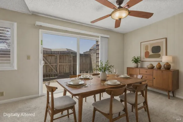 a view of a dining room with furniture and window