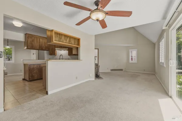 a view of a livingroom with a ceiling fan and window
