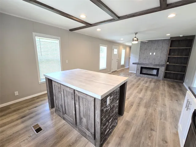 a view of a kitchen with furniture wooden floor and window