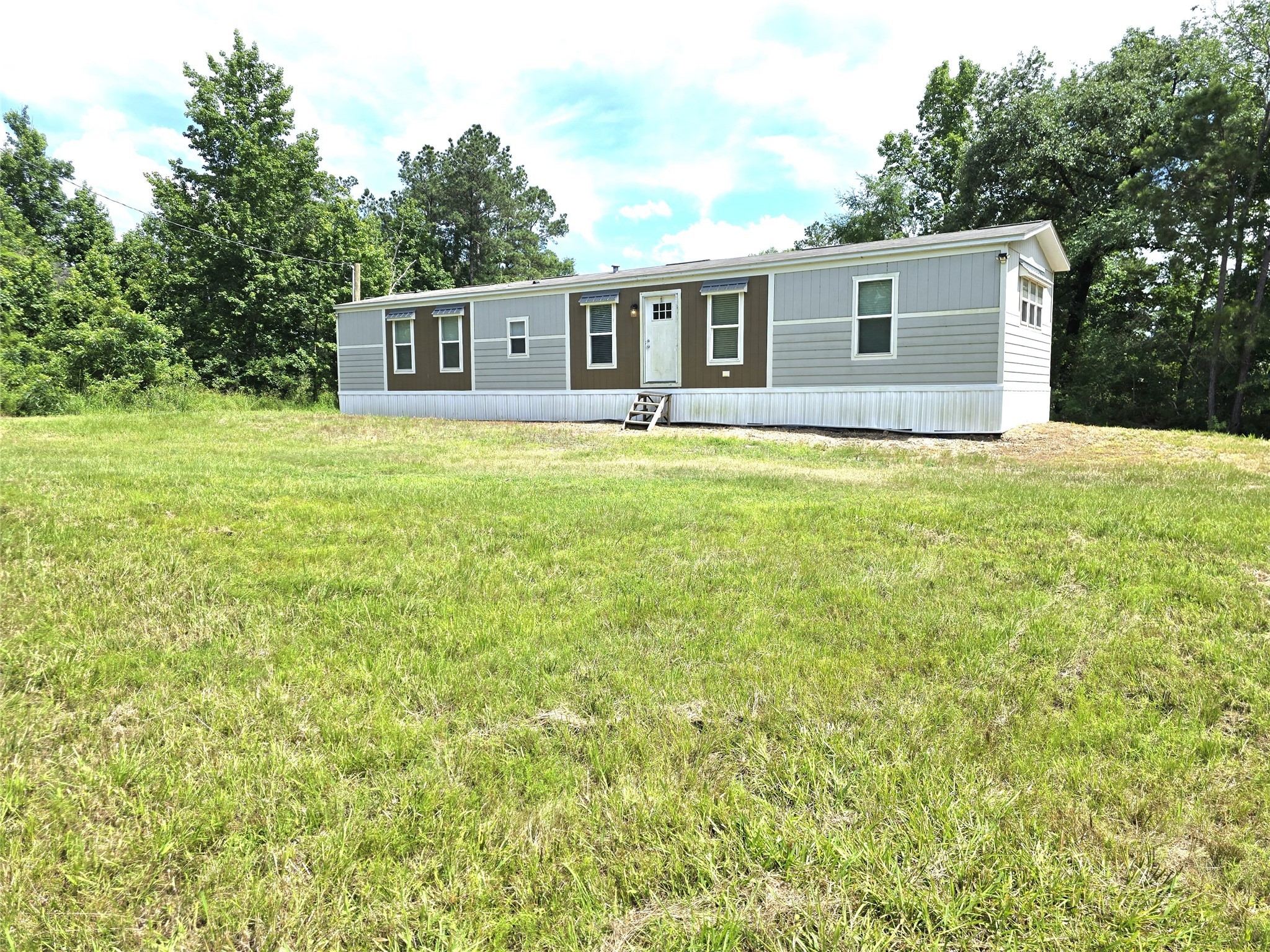215 Buffalo Way Drive Trinity, TX 75862 - Photo 15 of 17 a front view of house with yard and trees in the background
