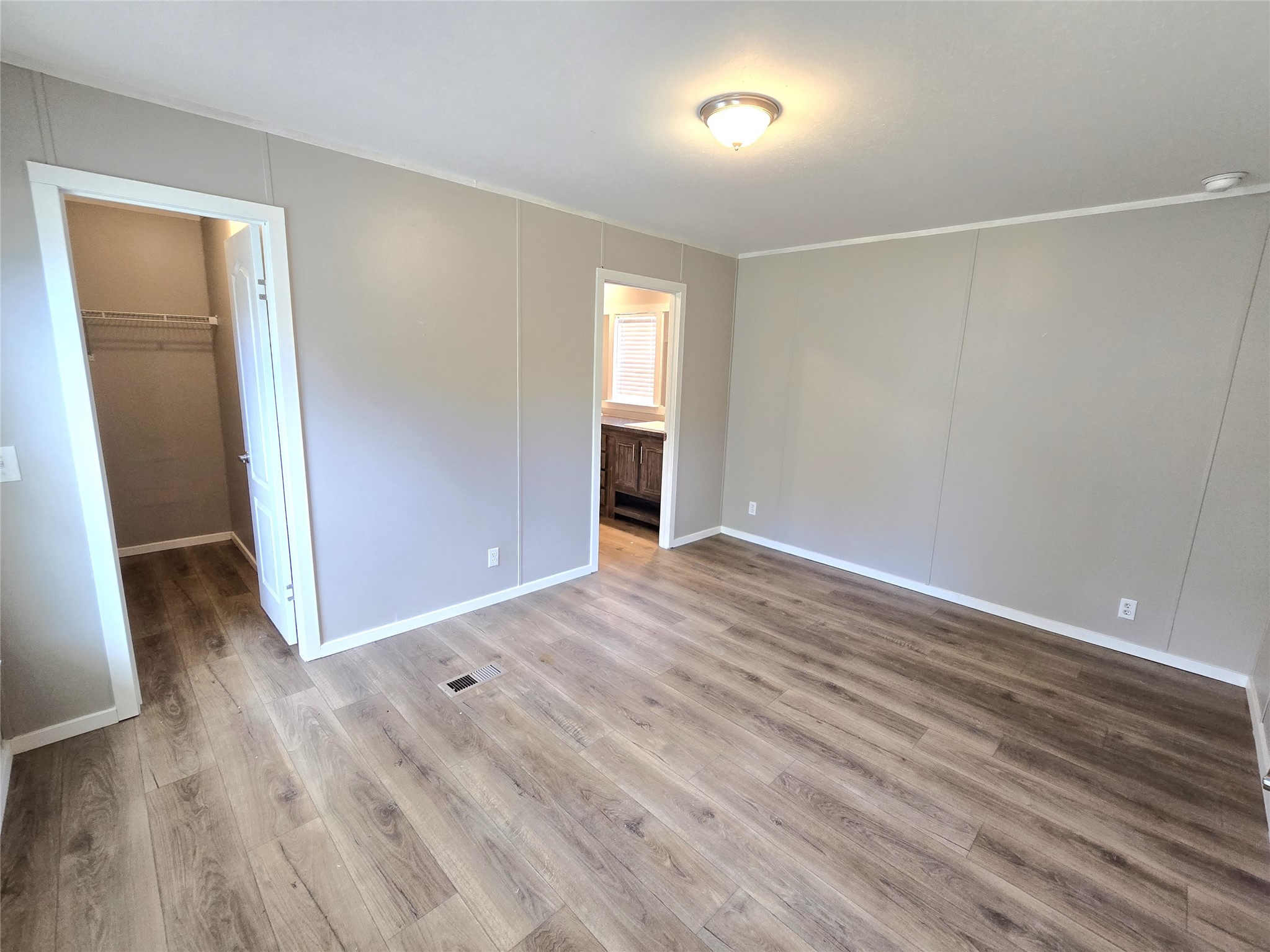 215 Buffalo Way Drive Trinity, TX 75862 - Photo 6 of 17 an empty room with wooden floor and windows