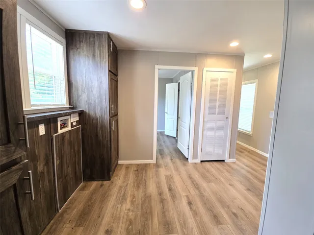 an empty room with wooden floor and closet
