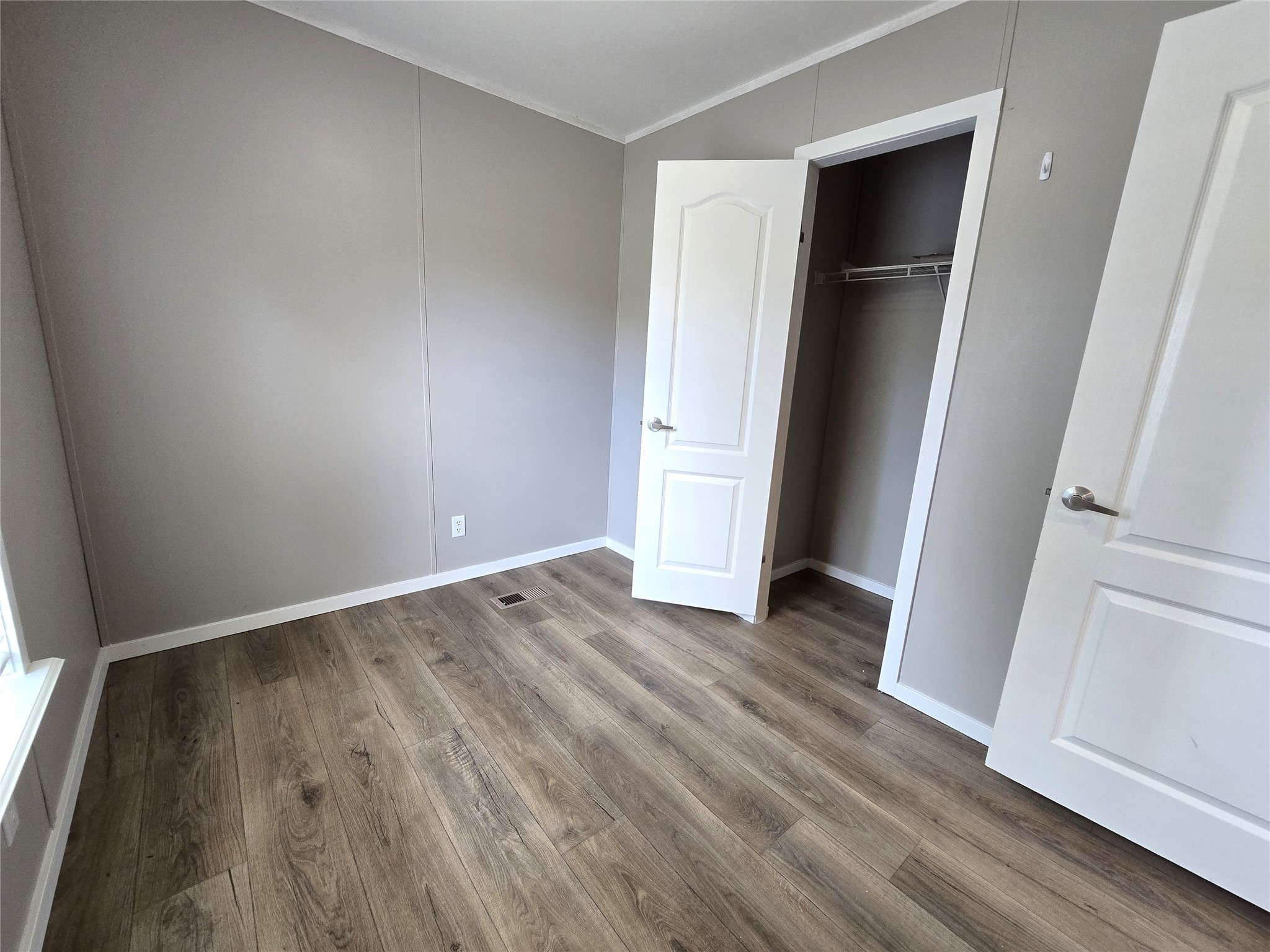 215 Buffalo Way Drive Trinity, TX 75862 - Photo 9 of 17 an empty room with wooden floor and closet