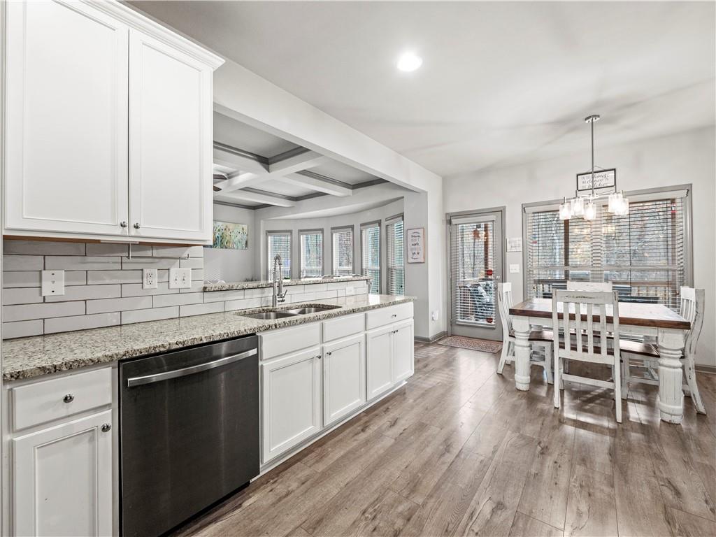 816 Mimosa Way Jefferson, GA 30549 - Photo 15 of 43 a kitchen with stainless steel appliances granite countertop wooden floors and white cabinets