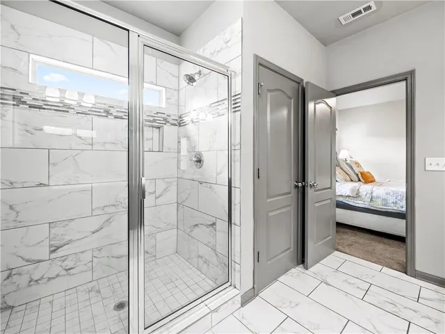 a bathroom with a tub and shower