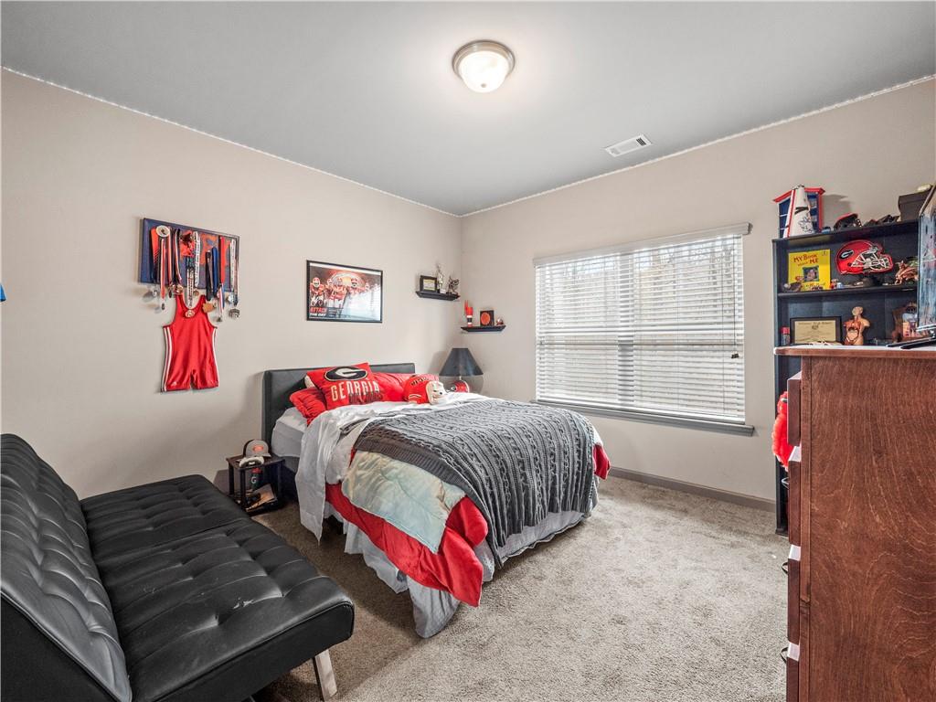 816 Mimosa Way Jefferson, GA 30549 - Photo 28 of 43 a bedroom with a bed and a couch