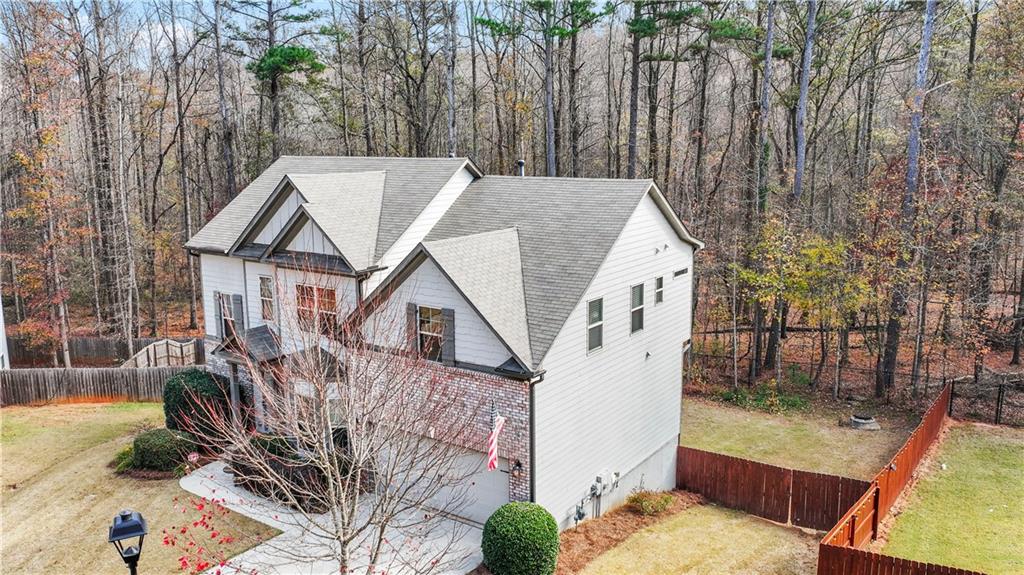 816 Mimosa Way Jefferson, GA 30549 - Photo 3 of 43 a view of a white house next to a yard with wooden fence
