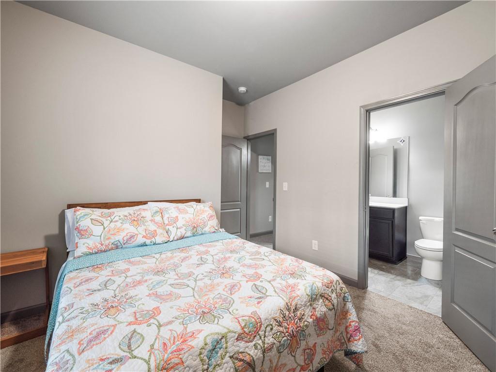 816 Mimosa Way Jefferson, GA 30549 - Photo 31 of 43 a bedroom with a large bed and a chandelier