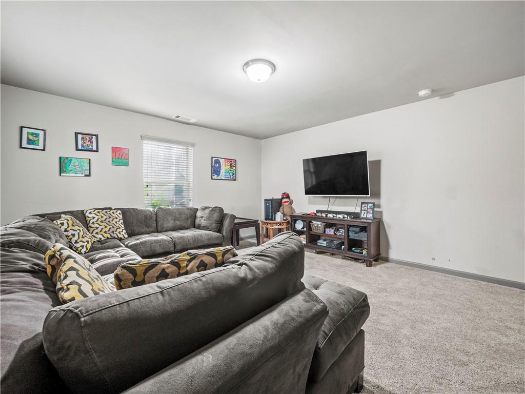 816 Mimosa Way Jefferson, GA 30549 - Photo 34 of 43 a living room with furniture and a flat screen tv
