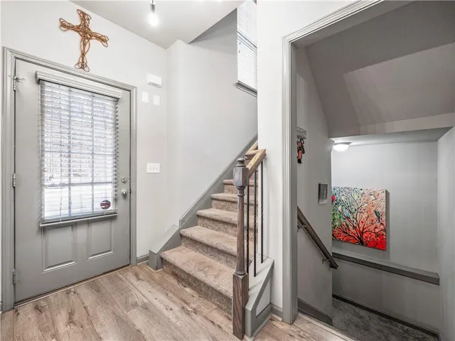 a view of entryway with stairs and wooden floor