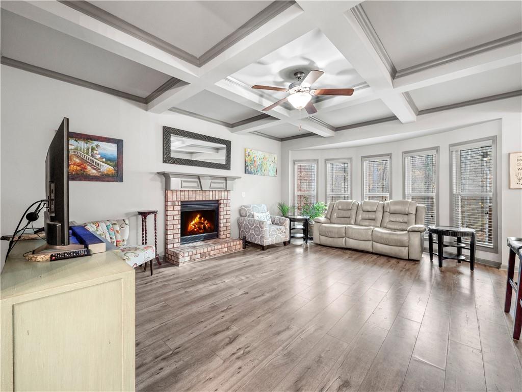 816 Mimosa Way Jefferson, GA 30549 - Photo 8 of 43 a view of a livingroom with furniture a fireplace wooden floor and chandelier