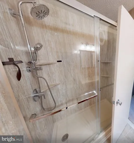 a bedroom with a bed a lamp and a window