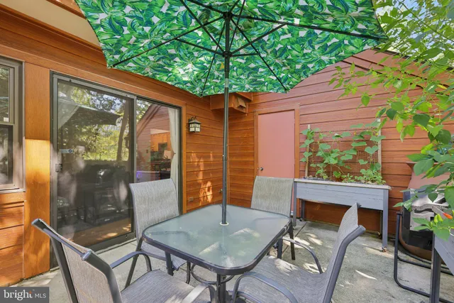 a view of a patio with table and chairs and potted plants