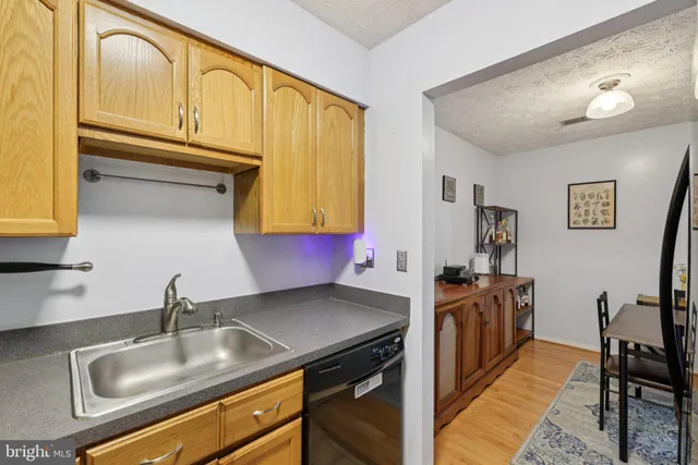 a kitchen with a sink a stove and cabinets