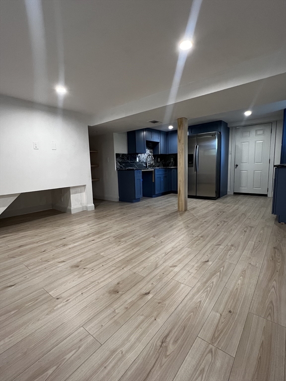 181 Christina Street, Unit 1 Newton, MA 02461 - Photo 20 of 24 a view of an empty room with wooden floor