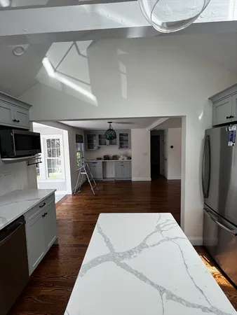 a kitchen with kitchen island a counter top space a sink and appliances