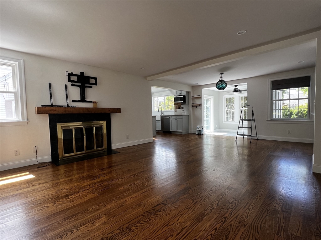 181 Christina Street, Unit 1 Newton, MA 02461 - Photo 4 of 24 a view of an empty room with window and wooden floor