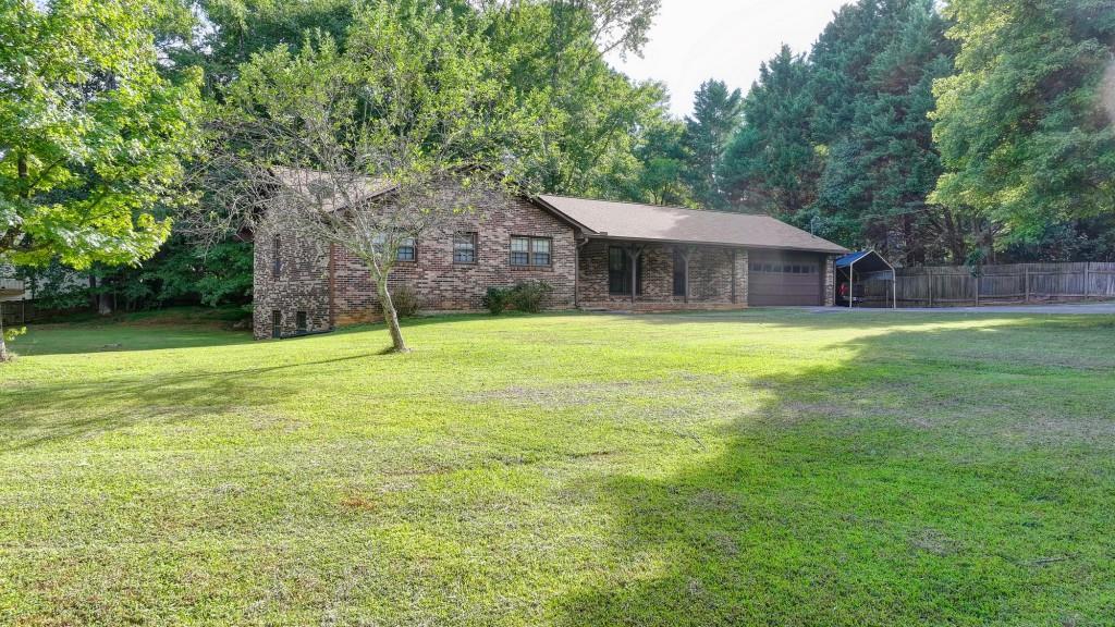 5680 Abbotts Bridge Road Johns Creek, GA 30097 - Photo 14 of 63 a view of a house with a yard