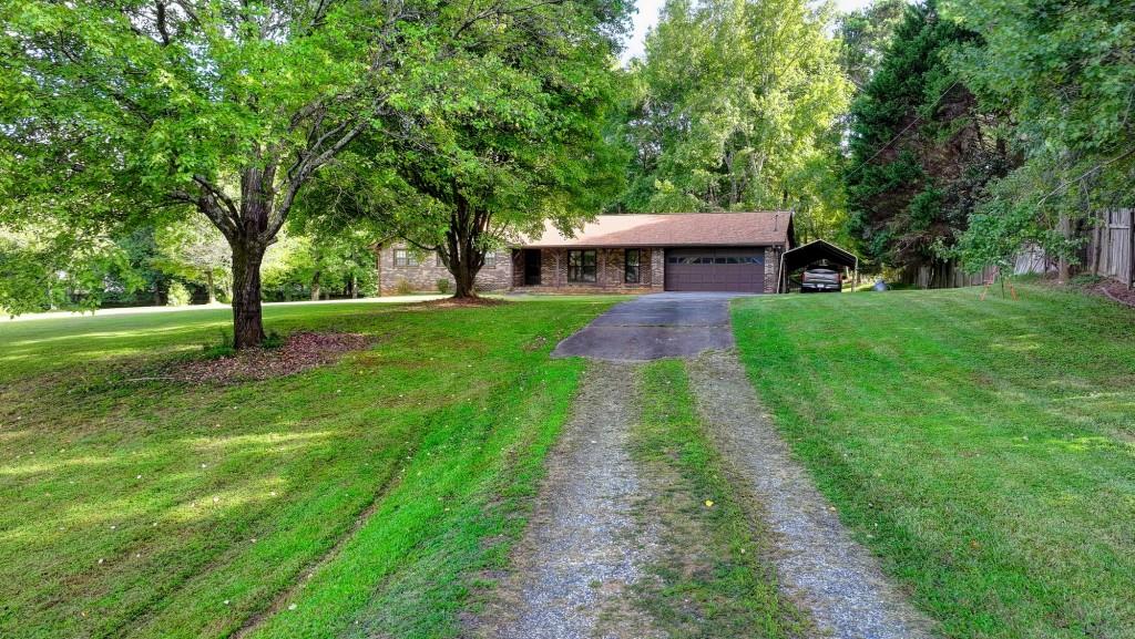 5680 Abbotts Bridge Road Johns Creek, GA 30097 - Photo 15 of 63 a front view of a house with a yard