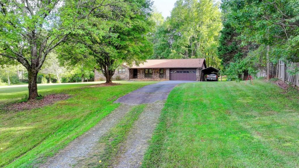 5680 Abbotts Bridge Road Johns Creek, GA 30097 - Photo 16 of 63 a front view of a house with yard and green space