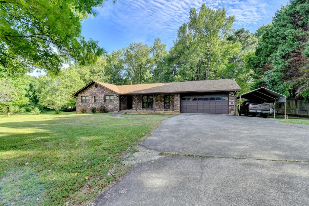 5680 Abbotts Bridge Road Johns Creek, GA 30097 - Photo 26 of 63 a front view of house with yard and green space