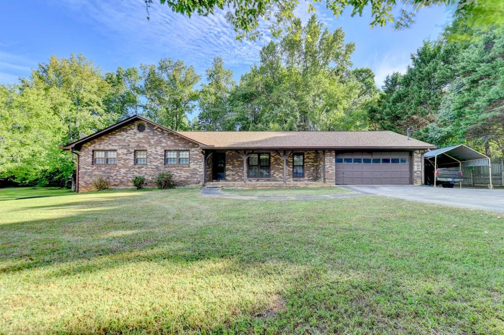 5680 Abbotts Bridge Road Johns Creek, GA 30097 - Photo 27 of 63 a front view of a house with a garden