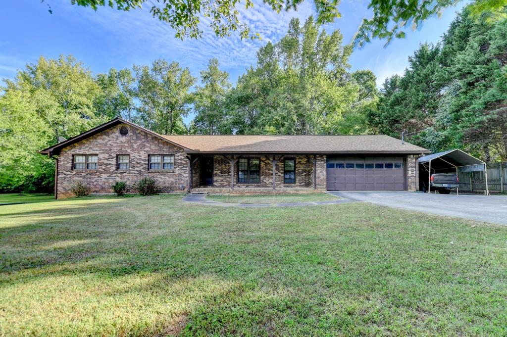 5680 Abbotts Bridge Road Johns Creek, GA 30097 - Photo 28 of 63 a front view of a house with a garden