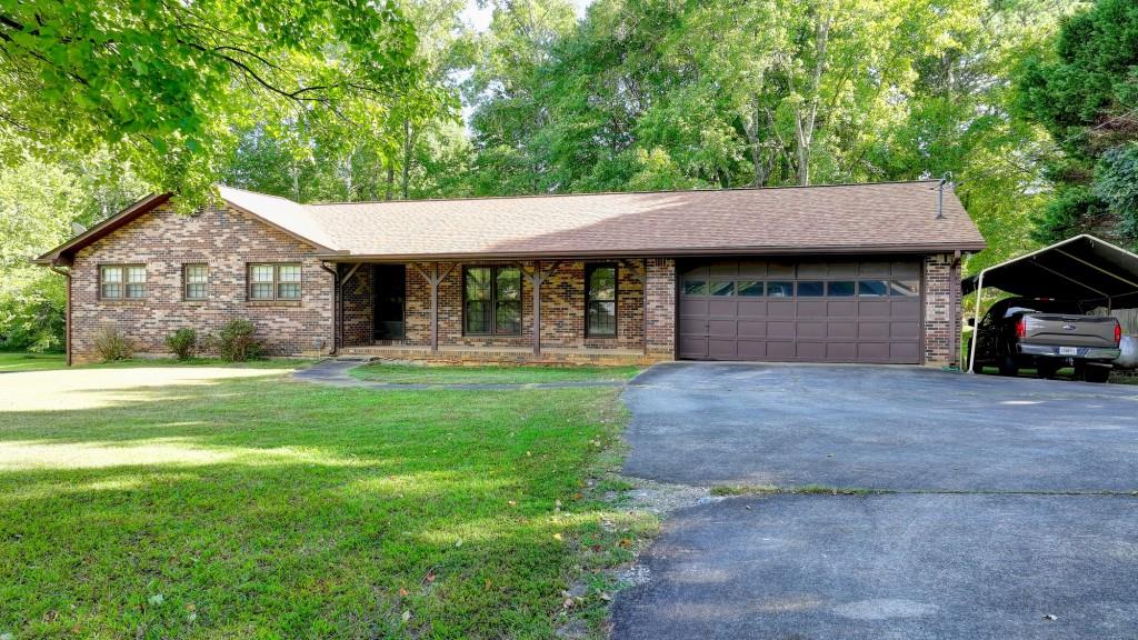 5680 Abbotts Bridge Road Johns Creek, GA 30097 - Photo 3 of 63 a view of a house with a yard plants and large tree