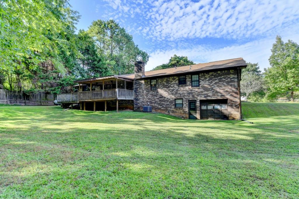 5680 Abbotts Bridge Road Johns Creek, GA 30097 - Photo 37 of 63 a view of a house with a big yard and large trees