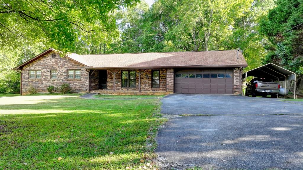 5680 Abbotts Bridge Road Johns Creek, GA 30097 - Photo 4 of 63 a front view of a house with garden