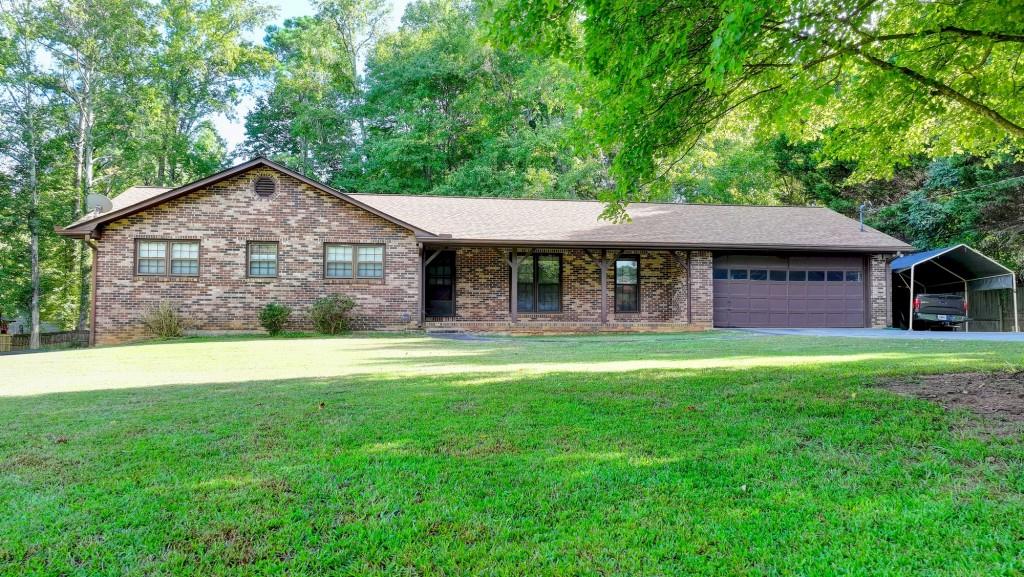5680 Abbotts Bridge Road Johns Creek, GA 30097 - Photo 6 of 63 a front view of a house with a garden and yard